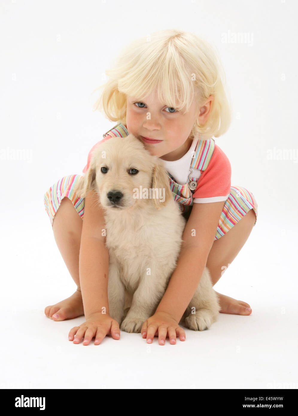 Portrait Of Young Blonde Haired Girl Sitting With Golden Retriever