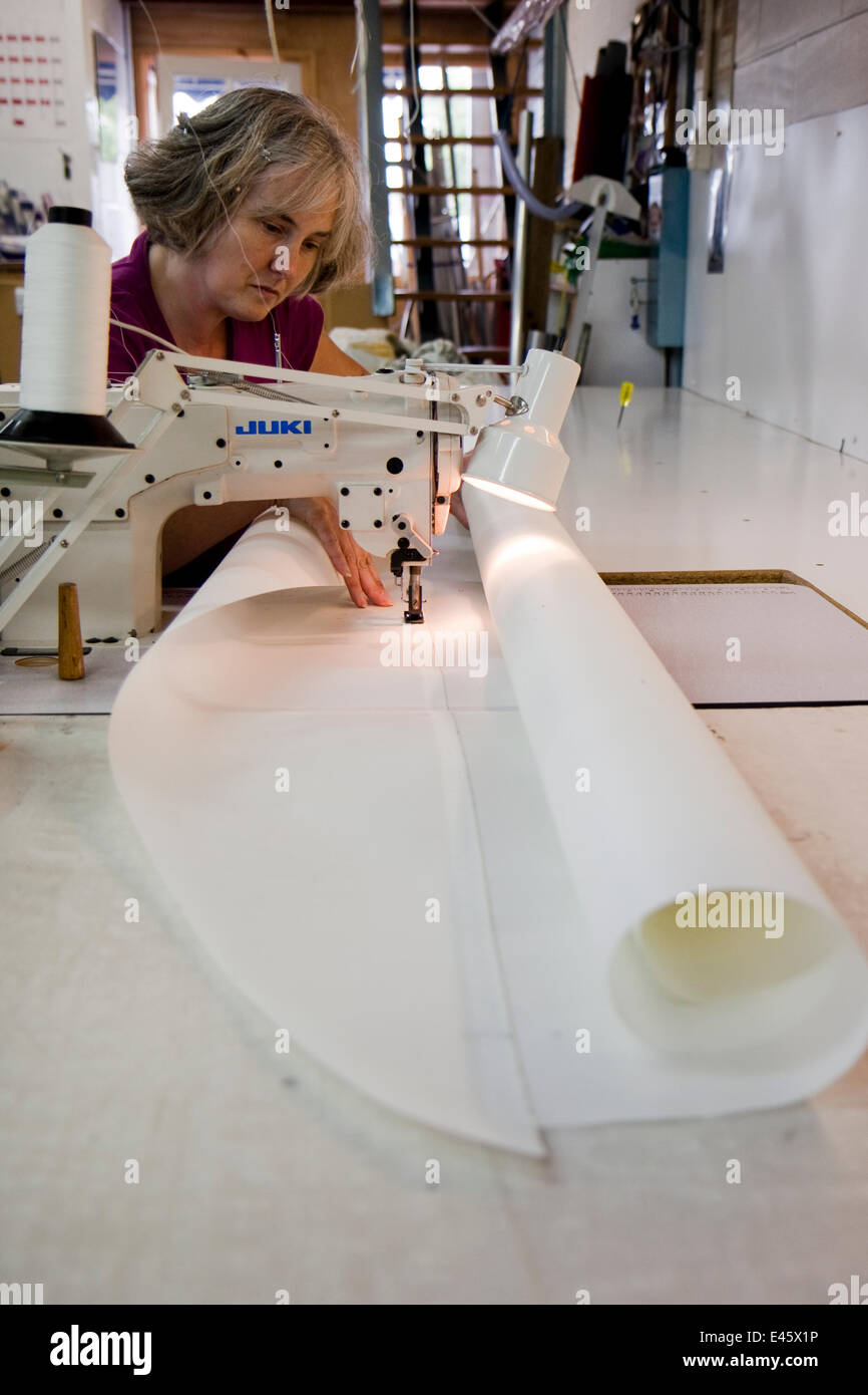 Sailmaker sewing panels together for a new mainsail, Bristol, England