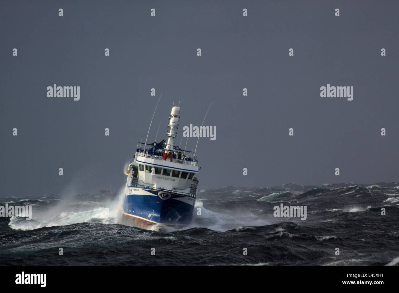 Fishing vessel 'Harvester' heading to North Sea fishing grounds in stormy weather. Europe, November 2010. Property released. Stock Photo