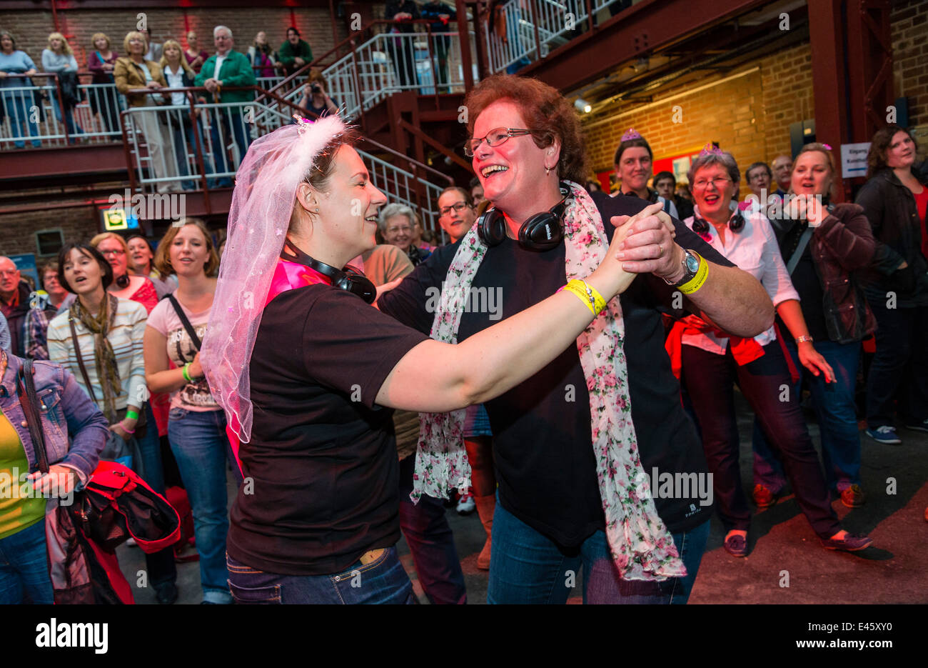 Cheerful participants enjoy 'Rudelsingen', coming together to sing at 'Extraschicht' - the annual night of industrial culture Stock Photo