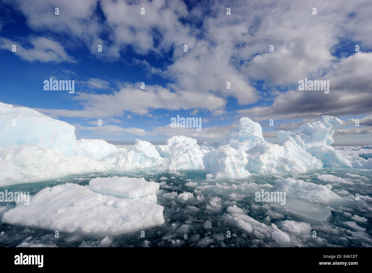 Melting ice under expansive clouds. Floe Edge, Arctic Bay, Baffin Island, Nunavut, Canada, April 2009. Stock Photo
