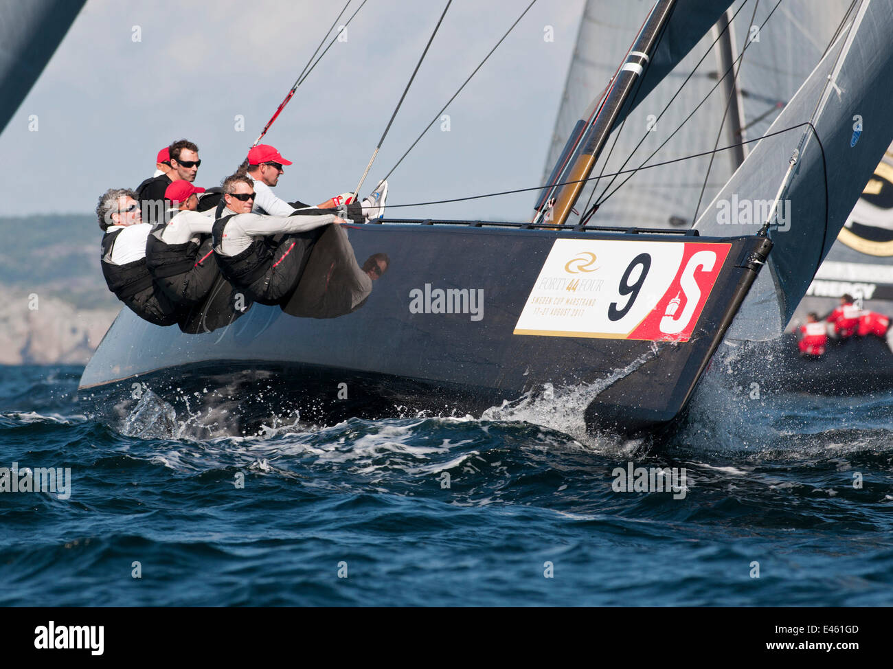 Crew hiking out on board yacht during the RC44 Sweden Cup, Marstrand
