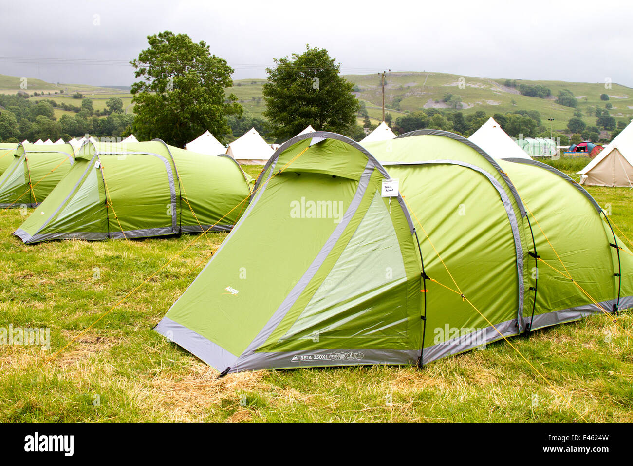 Pre-pitched tents in a field, rental camping accommodation in Kilnsey, Yorkshire Dales, July, 2014. Campers arrive and make preparations for the Tour de France. Thousands of cyclists have been in the Yorkshire Dales travelling the route of the Grand Depart. The fields assigned to parking and camping are now beginning to fill up in preparation for the cycling event on Saturday. Stock Photo