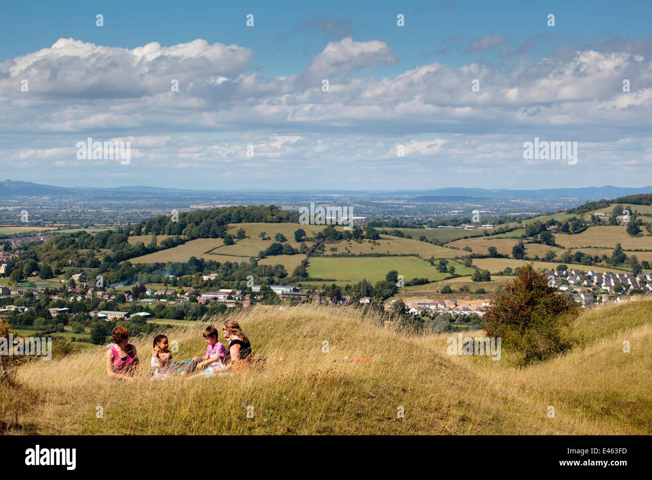 Women and children having a picnic high up on Selsley Common unimproved grassland, Stroud, Gloucestershire, UK, August 2011. Model released Stock Photo