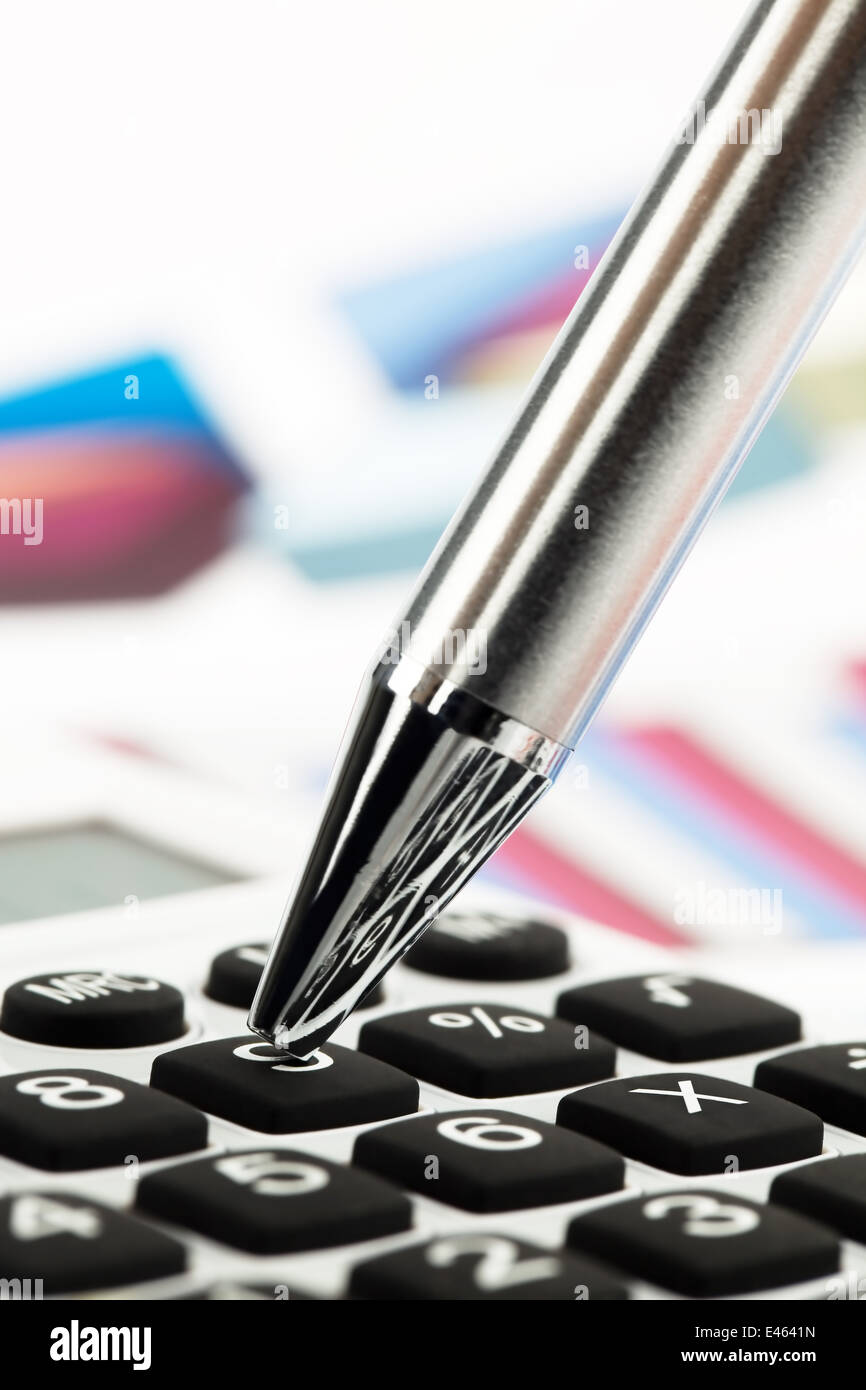 A calculator and various statistics when calculating the balance sheet, revenue and profit. Stock Photo