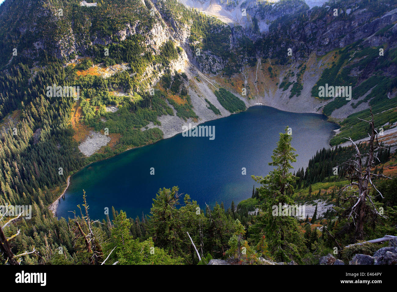 Lake Ann surrounded by Douglas firs (Pseudotsuga menziesii) Silver firs (Abies alba) and other conifers in the area of Rainy Pass of North Cascades National Park, North Cascades National Park, Cascade Range, Washington, October 2009. Stock Photo