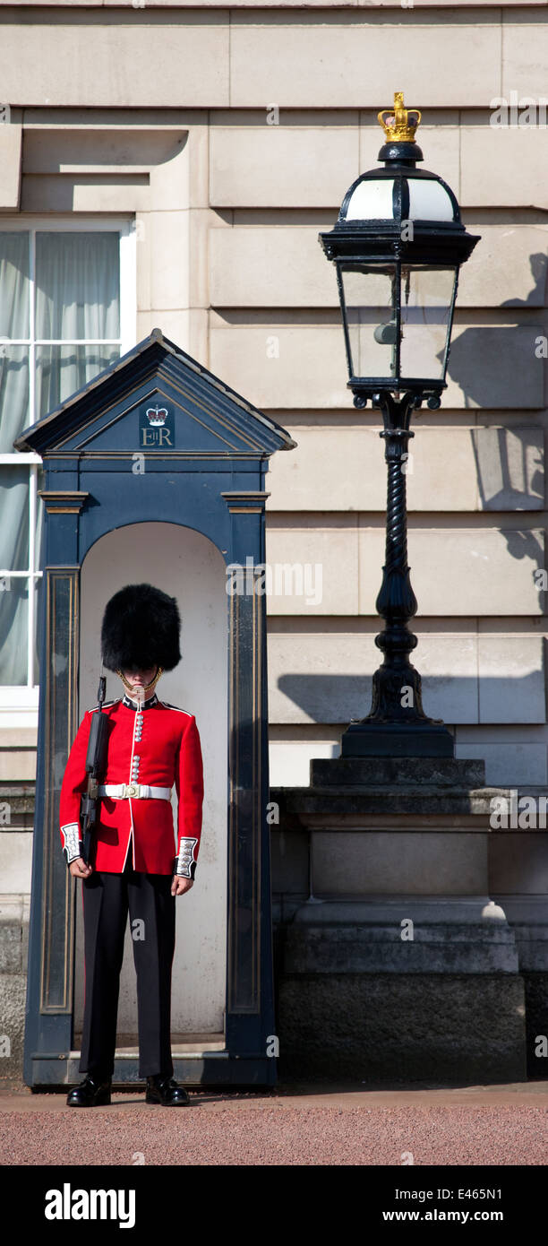 LONDON, UK - MAY 16TH 2014: A Queen's Guard outside the historic Buckingham Palace in London on 16th May 2014. Stock Photo