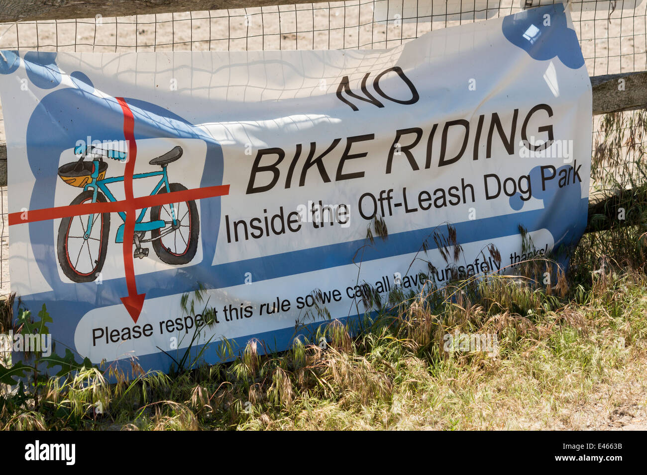 Banner sign for No Bike Riding on the off leash dog park at Cherry
