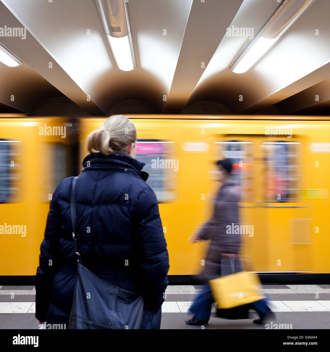 Moving train pulling into the station with people waiting, modern subway station, Berlin, Germany, 2009 Stock Photo