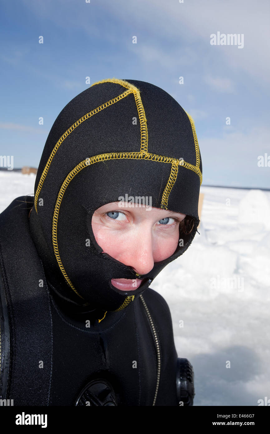 Scuba diver with special head hood for cold water diving, Arctic circle