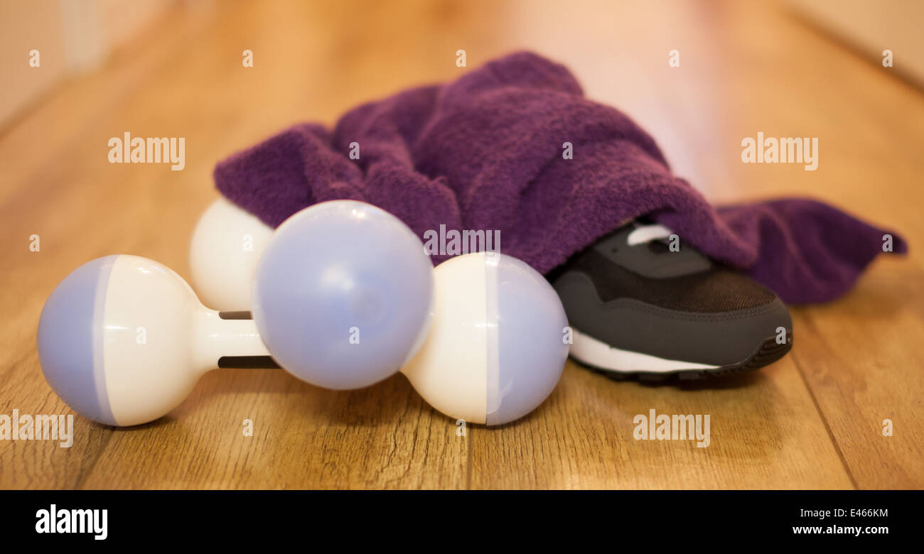 Dumbbells towel and trainer after workout Stock Photo
