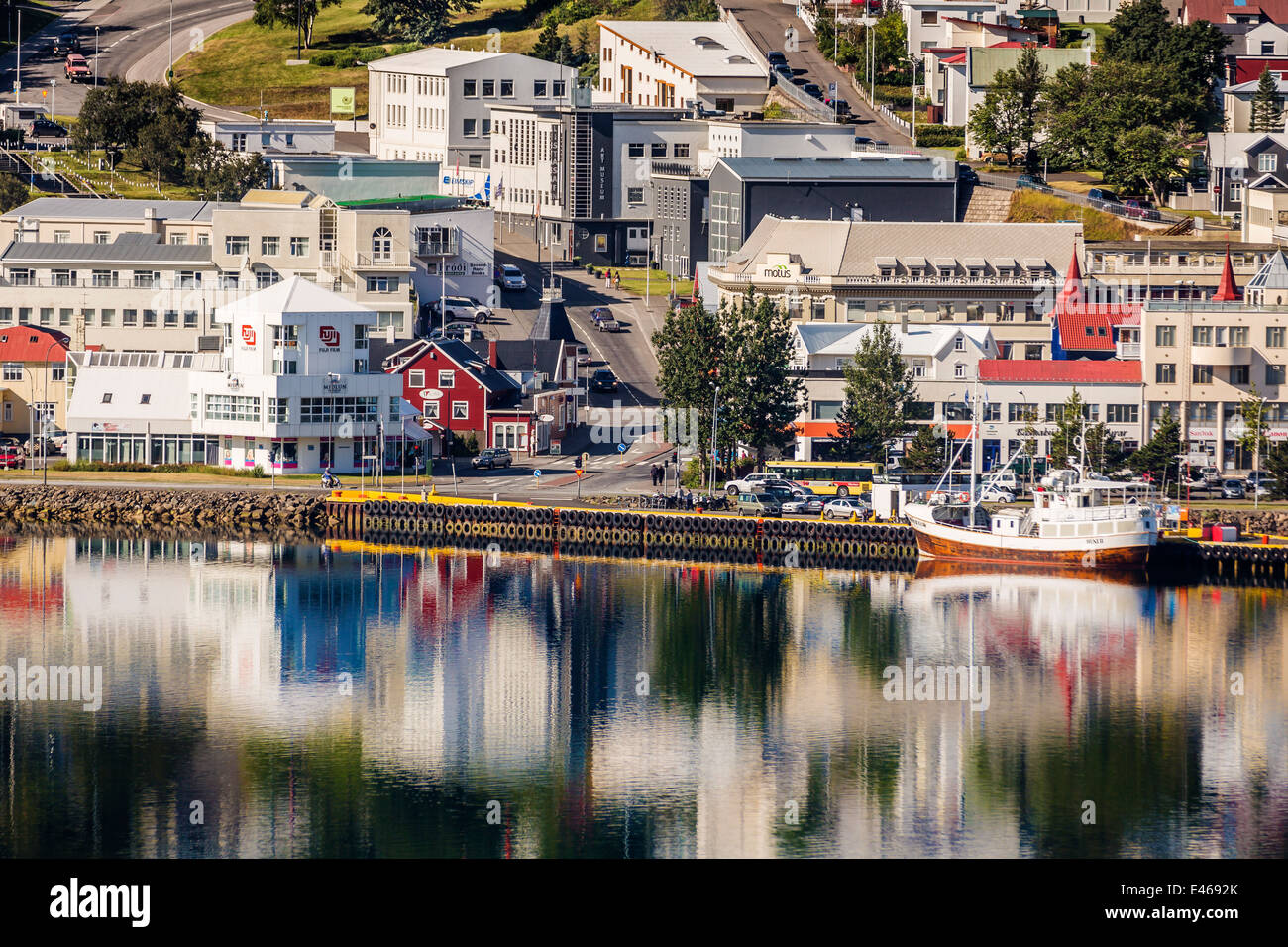 Boat docked with Homes and Apartments, Akureyri, Iceland Stock Photo