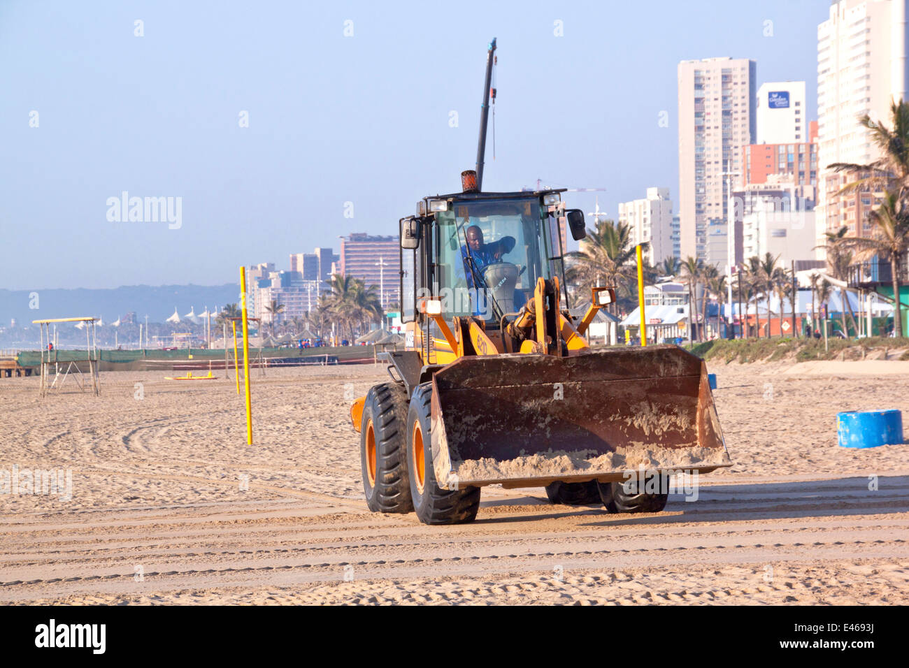 DURBAN, SOUTH AFRICA JULY 2, 2014; Pay loader works on beach on