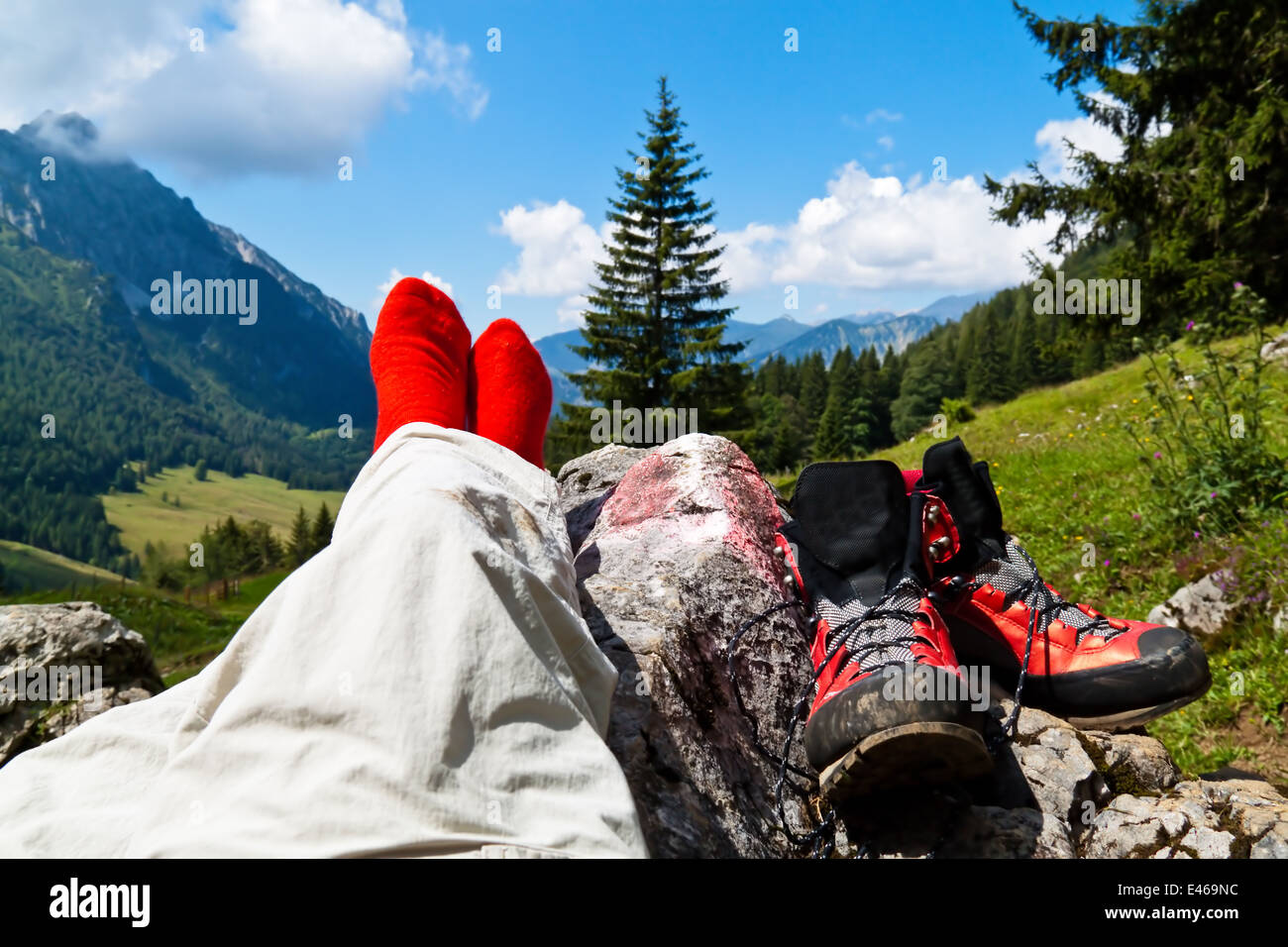Red hiking boots on a hike in the mountains of Austria. Activity during leisure time Stock Photo