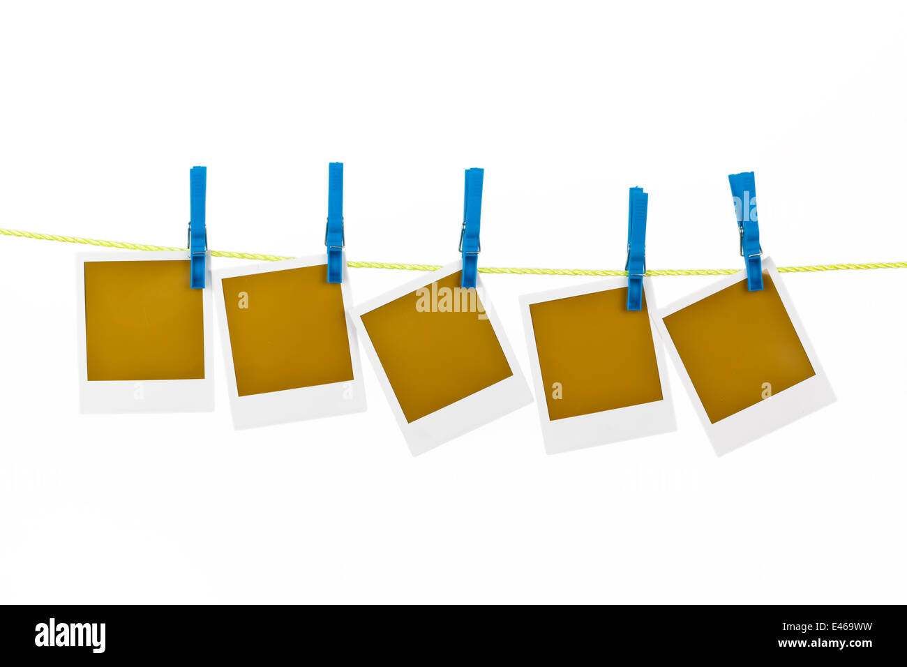 Several photographs hanging on a clothesline and are fixed with clothespins Stock Photo