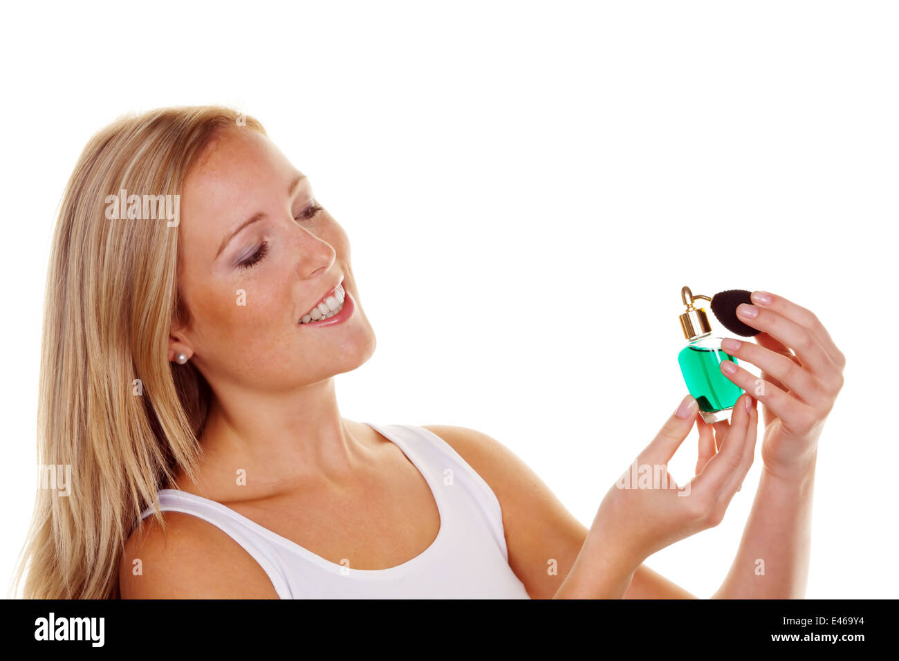 A young woman with a bottle of perfume, cosmetics and personal hygiene Stock Photo