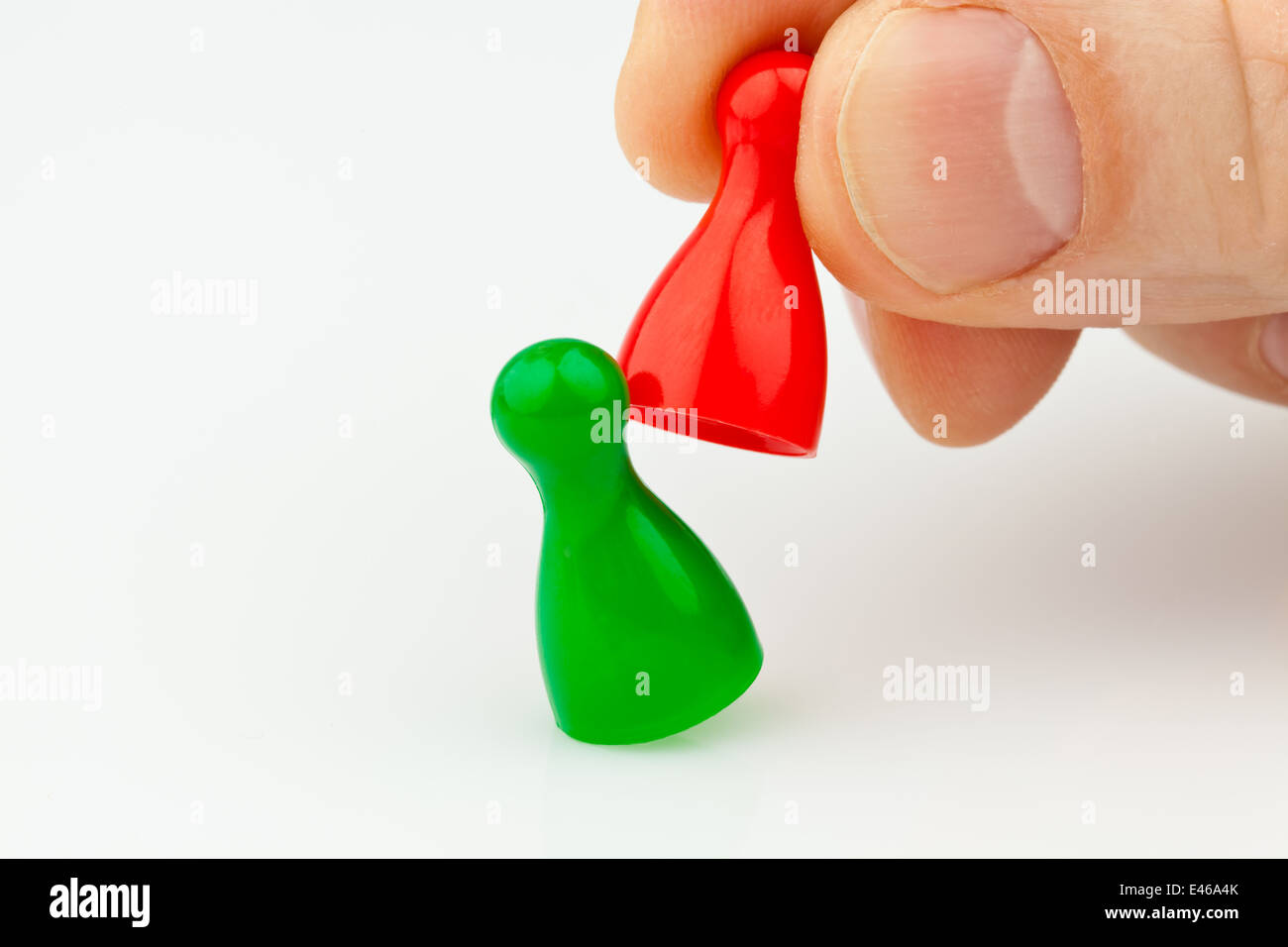Red and green tokens. Bullying, loneliness and outsider in the team. Stock Photo
