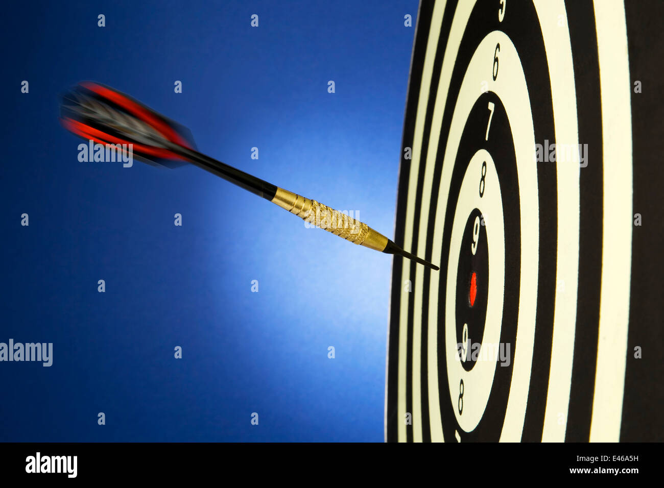 An arrow game with a dart has hit the mark. Stock Photo