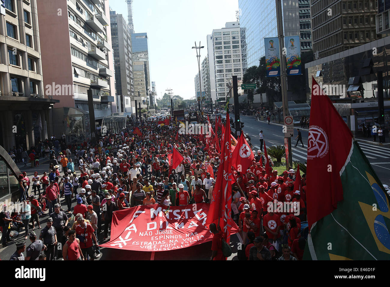 (140703) -- BRAZIL, SAO PAULO, July 03, 2014 (Xinhua) -- Protesters attend a demonstration in the street of Sao Paulo, Brazil, on July 3, 2014. Members of social movements such as Landless Workers' Movement (MTS) and Homeless Workers' Movement (MST) gathered in Sao Paulo on Thursday, raising muliple demands pertaining to reforms on lands and agriculture to Brazilian Government. (Xinhua/Rahel Patrasso) Stock Photo