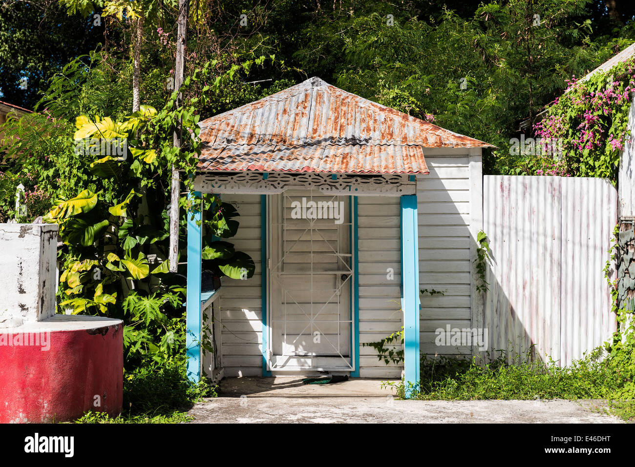 A tiny, and what appears to be a one-room home with a rusted tin roof, in Frederiksted, St. Croix, U.S. Virgin Islands. Stock Photo