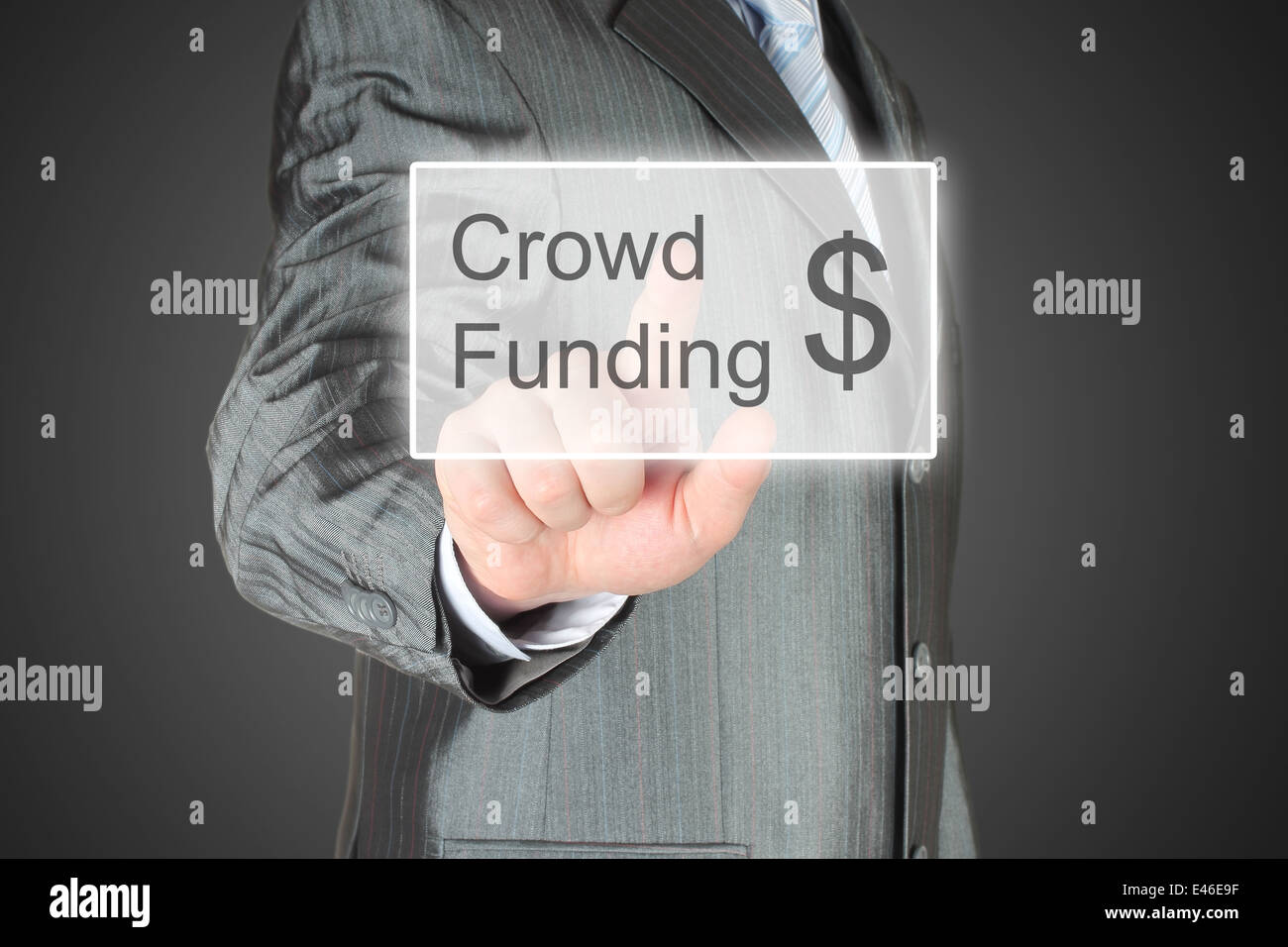 Businessman pushes virtual crowd funding button on dark background Stock Photo