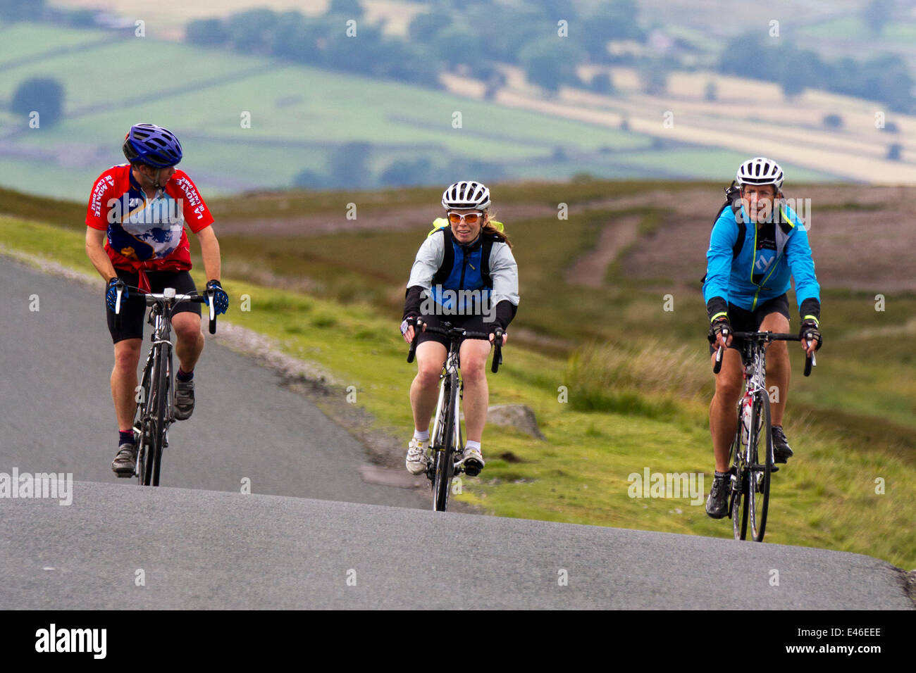 Grinton, Yorkshire Dales, UK 3rd July, 2014. Three cyclists on the ...