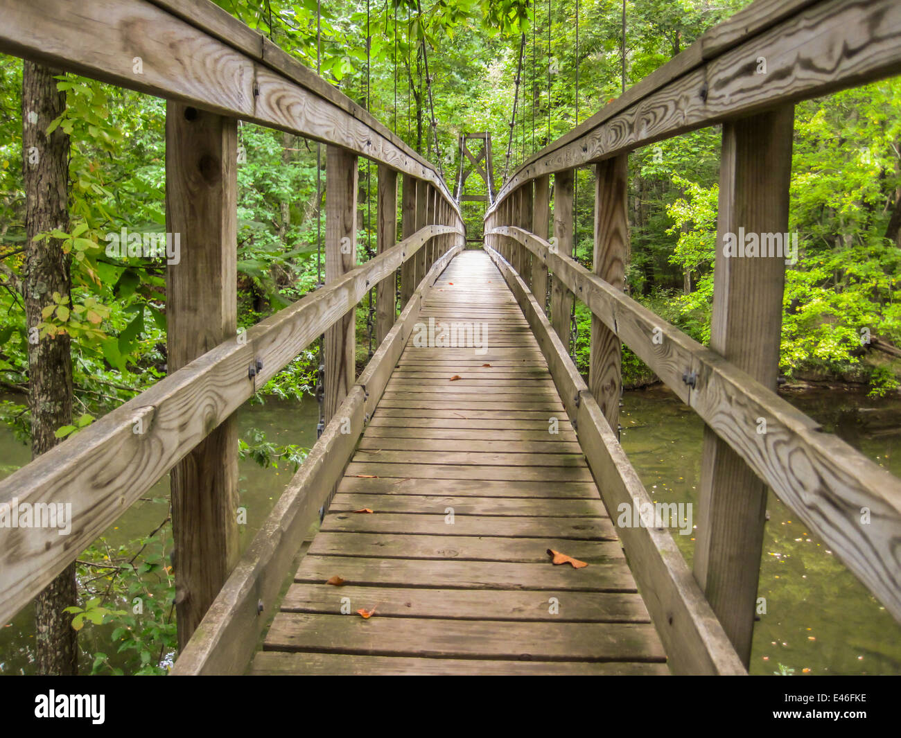 A wooden footbridge on the Appalachian Trail provides safe crossing for hikers over a river Stock Photo