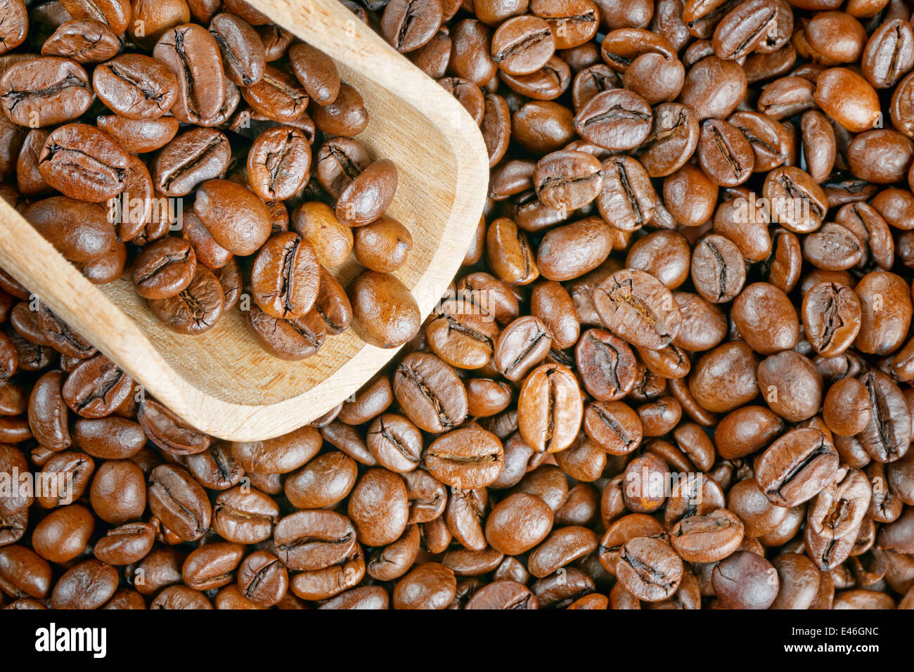 top view closeup coffee beans wood scoop Stock Photo