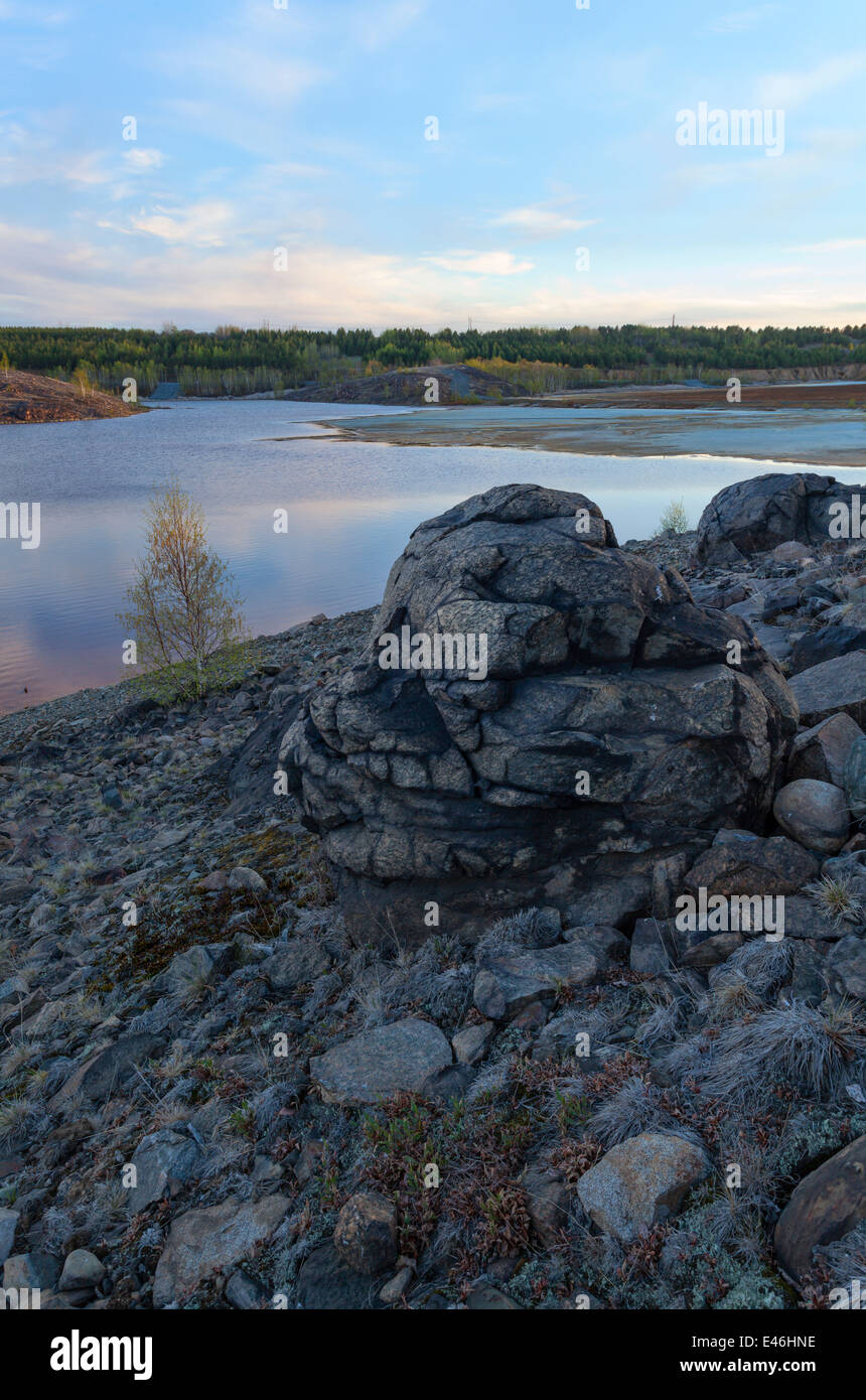 Large rocks on a hillside overlooking a tailings pond in Sudbury near the Vale Mining operations. Sudbury, Ontario, Canada. Stock Photo