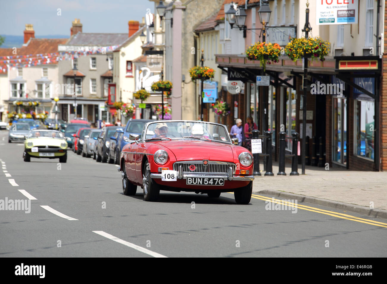 Classic Cars and Bikes driving through Thornbury Town taking part in