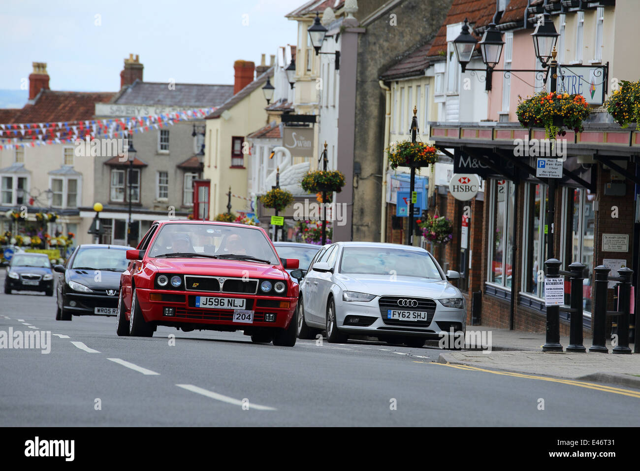 Classic Cars and Bikes driving through Thornbury Town taking part in