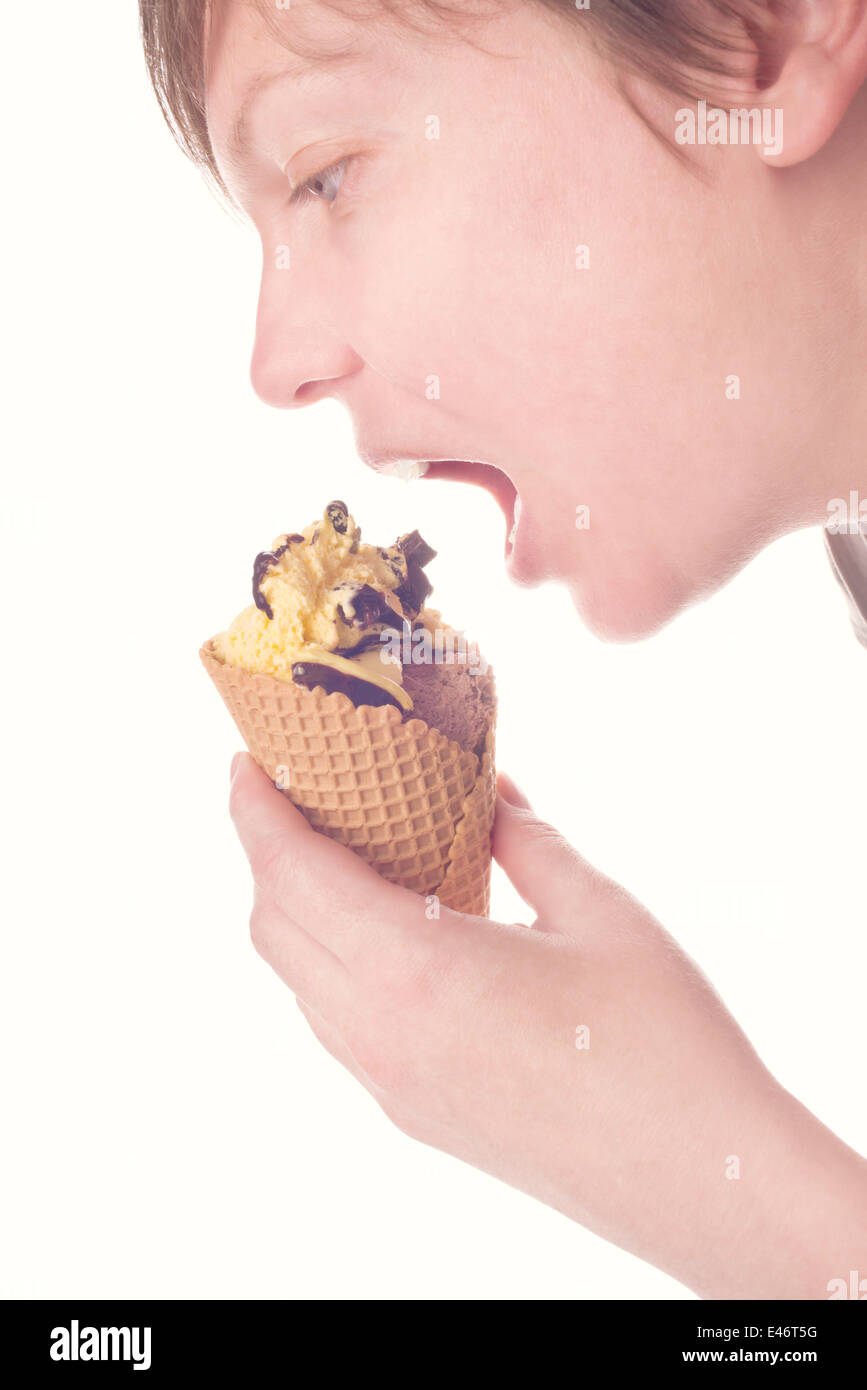 Woman eating chocolate ice cream in a cone. Stock Photo