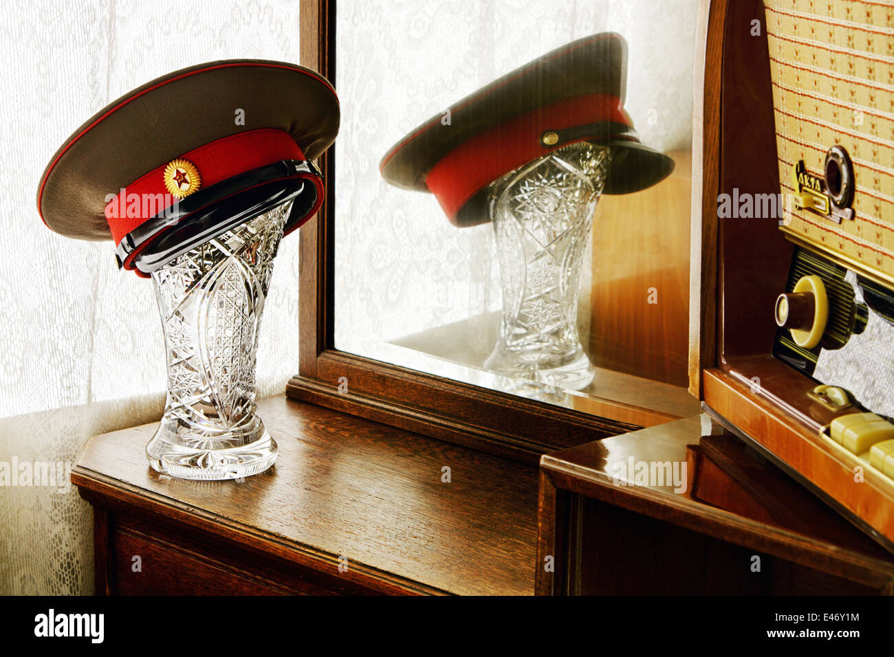 Soviet place of honor. Mirror, Latvian radiola and officer's cap on the crystal vase Stock Photo