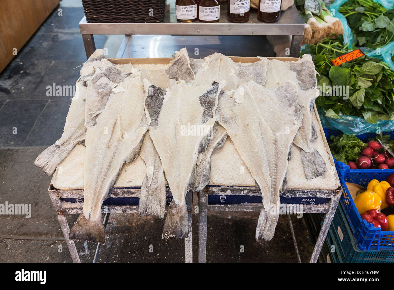 Salted fillets of dried white fish displayed for sale in the covered