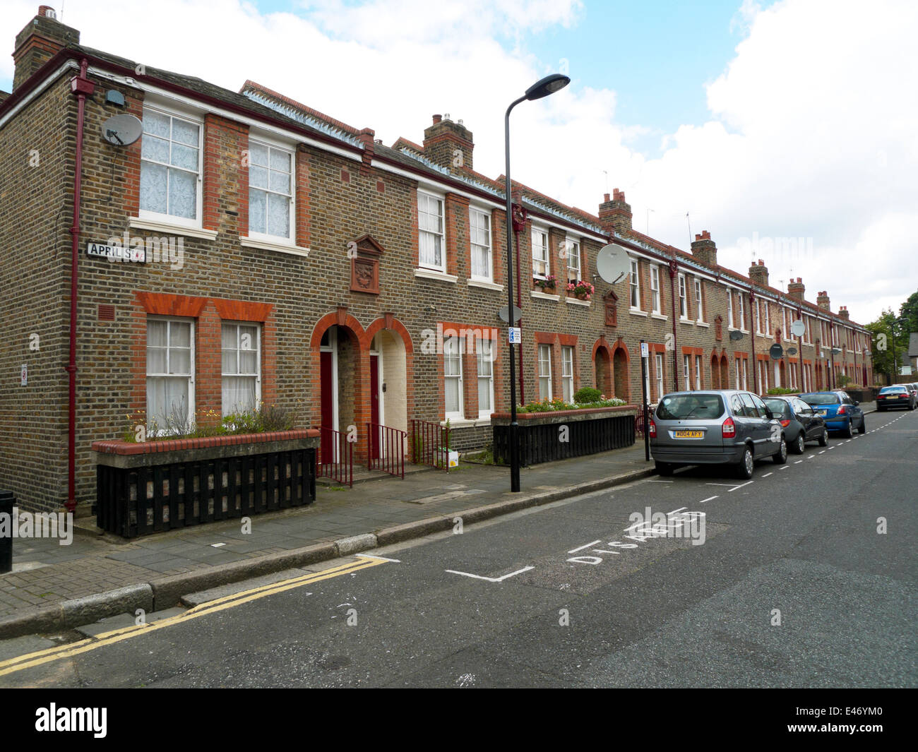 Row of terraced houses on April Street with disabled parking space marked Dalston Hackney East London E8 England UK KATHY DEWITT Stock Photo