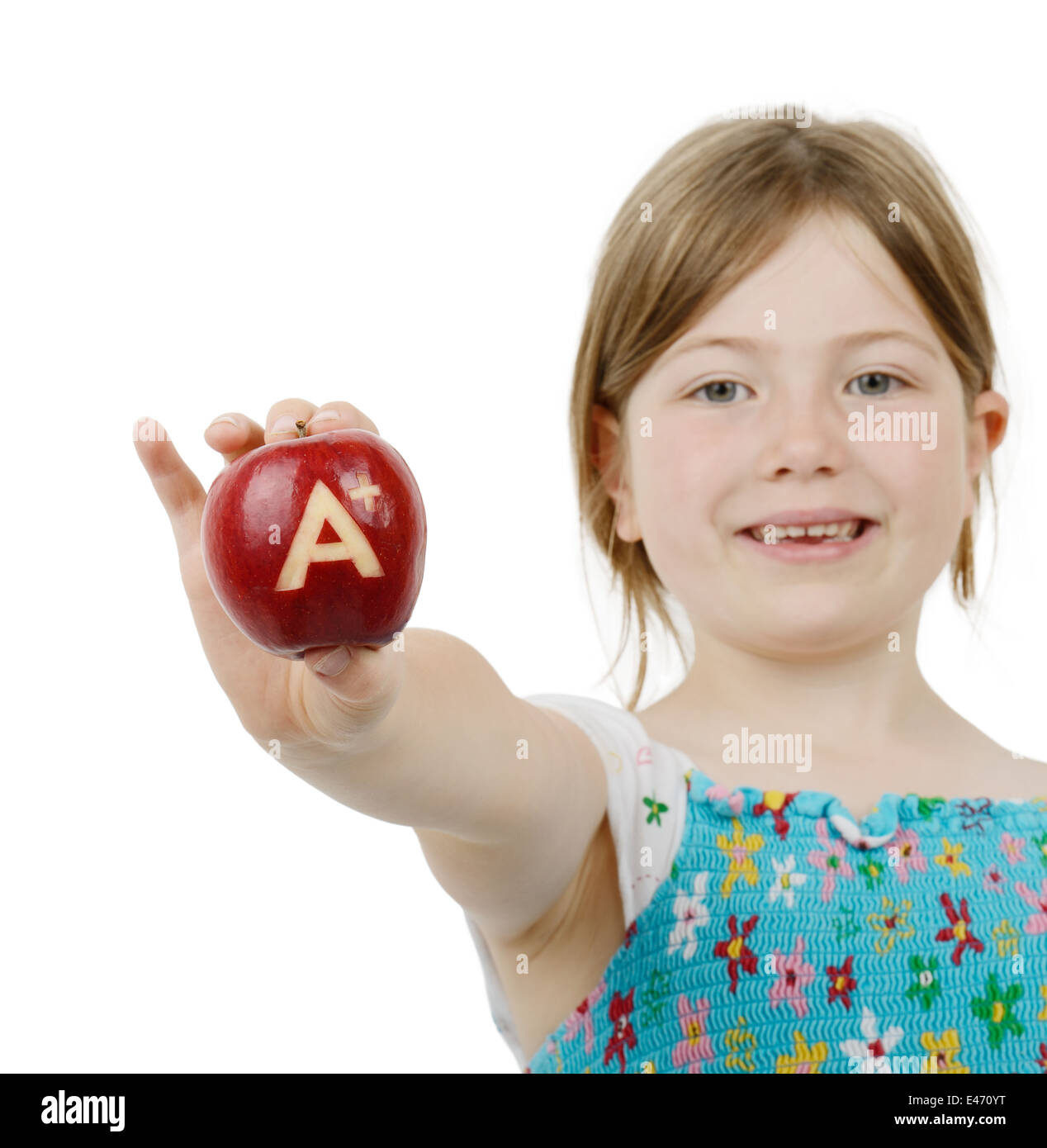 school girl with top marks an a plus symbol on a red apple, isolated on a white background Stock Photo
