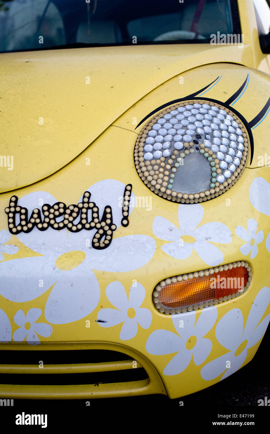 Tweety-Version of a VW Beetle, with flower decoration and headlight-eyes with eyelashes, in June 2014. Stock Photo