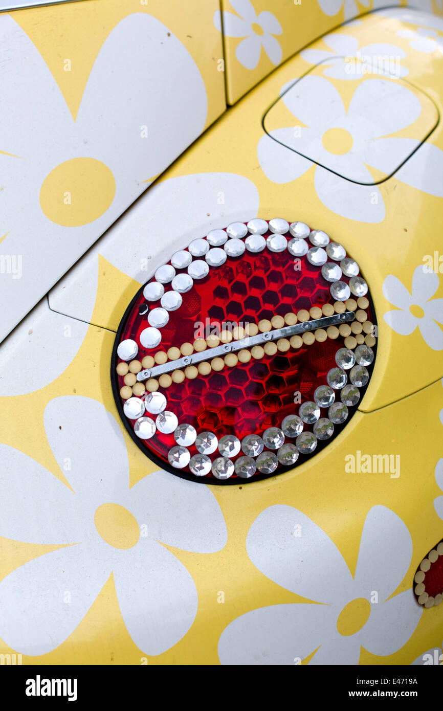 Tweety-Version of a VW Beetle, with flower decoration and ornamented tail lights, in June 2014. Stock Photo