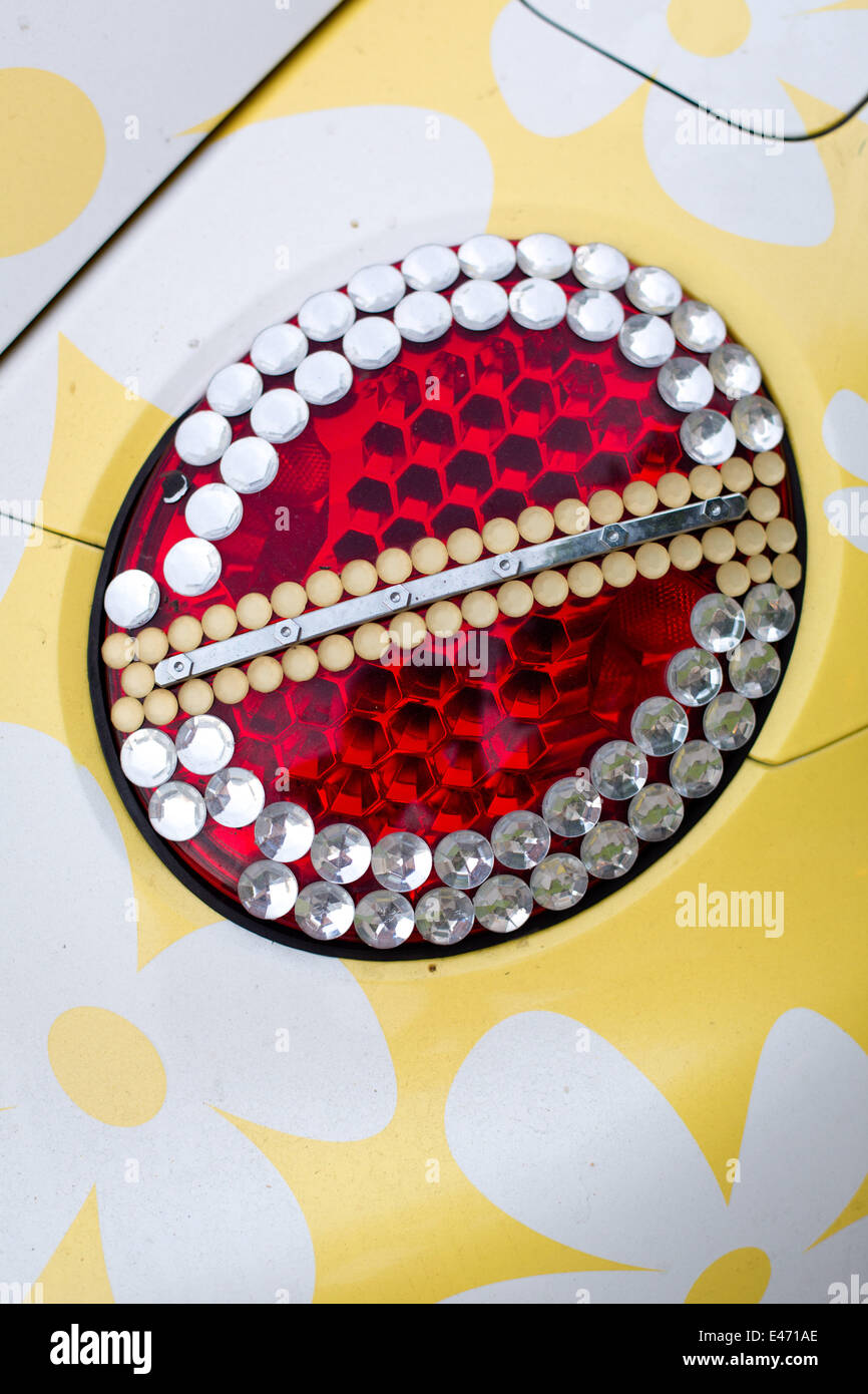 Tweety-Version of a VW Beetle, with flower decoration and ornamented tail lights, in June 2014. Stock Photo