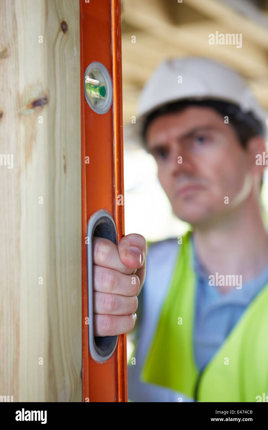 Builder Checking Work With Spirit Level Stock Photo - Alamy