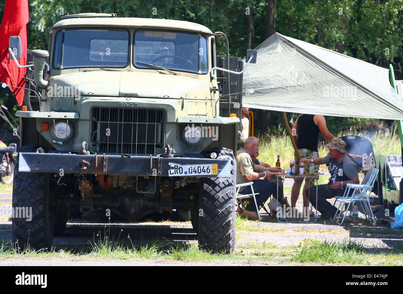 Puetnitz, Germany. 04th July, 2014. Members of the 13th international meeting of Eastern bloc vehicles are pictured on the former army area in Puetnitz, Germany, 04 July 2014. During the weekend more than 2500 vehicles are expected which also participate on gateways and parades. Photo: Jens Buettner/dpa/Alamy Live News Stock Photo