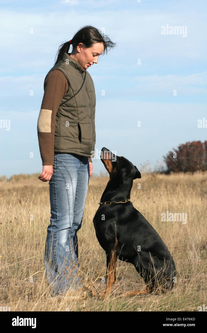 Hunky male model wearing tux and doberman