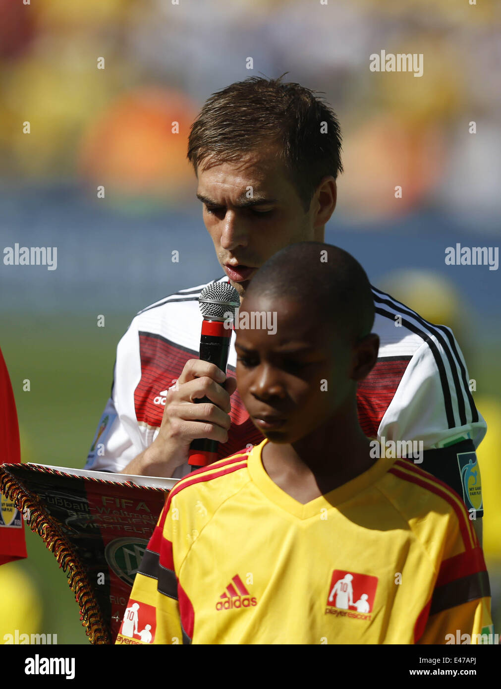 Rio De Janeiro, Brazil. 4th July, 2014. Germany's Philipp Lahm (back) speaks before a quarter-finals match between France and Germany of 2014 FIFA World Cup at the Estadio do Maracana Stadium in Rio de Janeiro, Brazil, on July 4, 2014. Credit:  Wang Lili/Xinhua/Alamy Live News Stock Photo