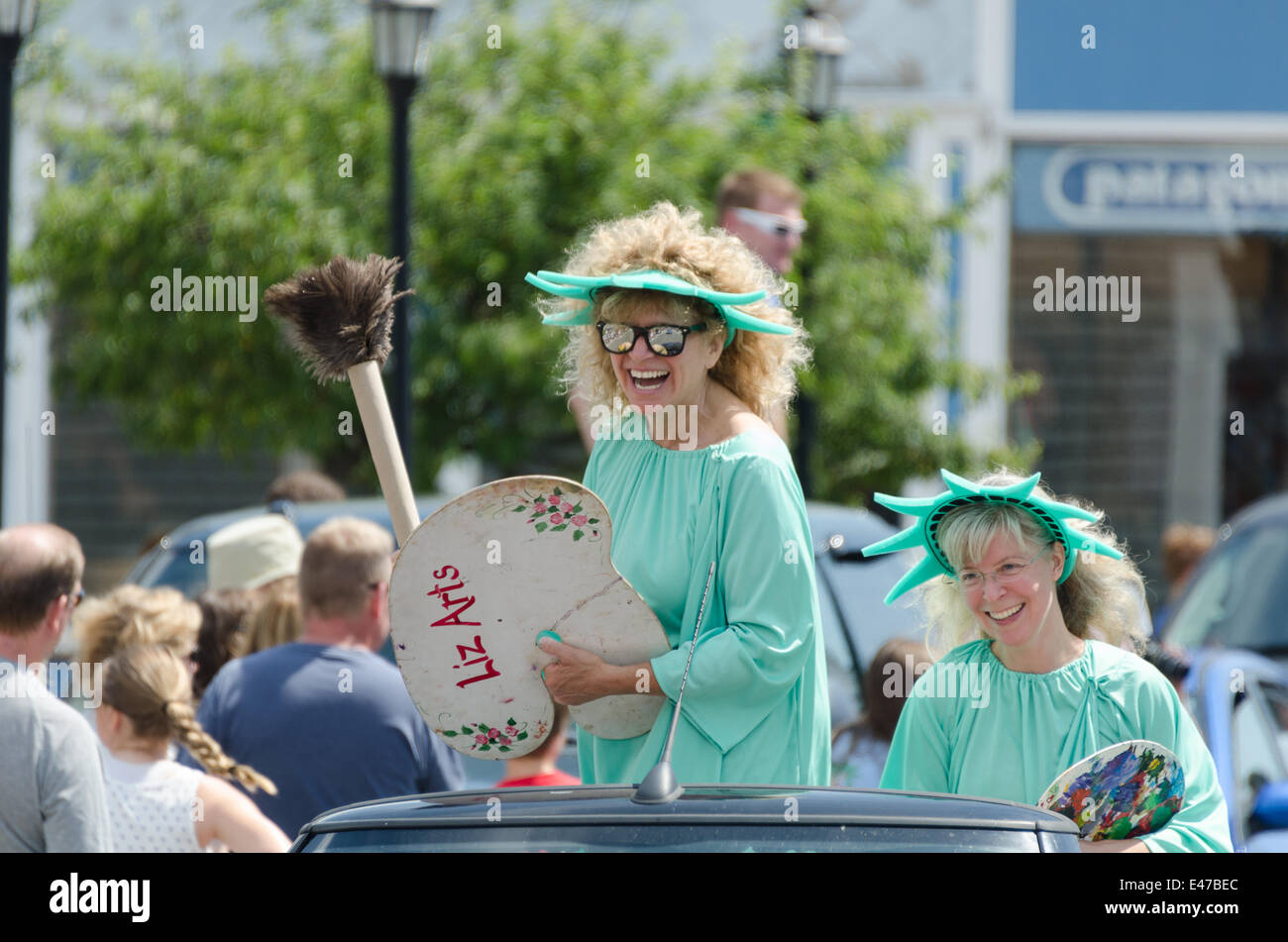 Bar Harbor, Maine, USA. 04th July, 2014. Independence Day Parade Bar Harbor Maine. Pictured: Two artists dressed as the Statue of Liberty on the ArtWaves Studio float in the Independence Day Parade Credit:  Jennifer Booher/Alamy Live News Stock Photo