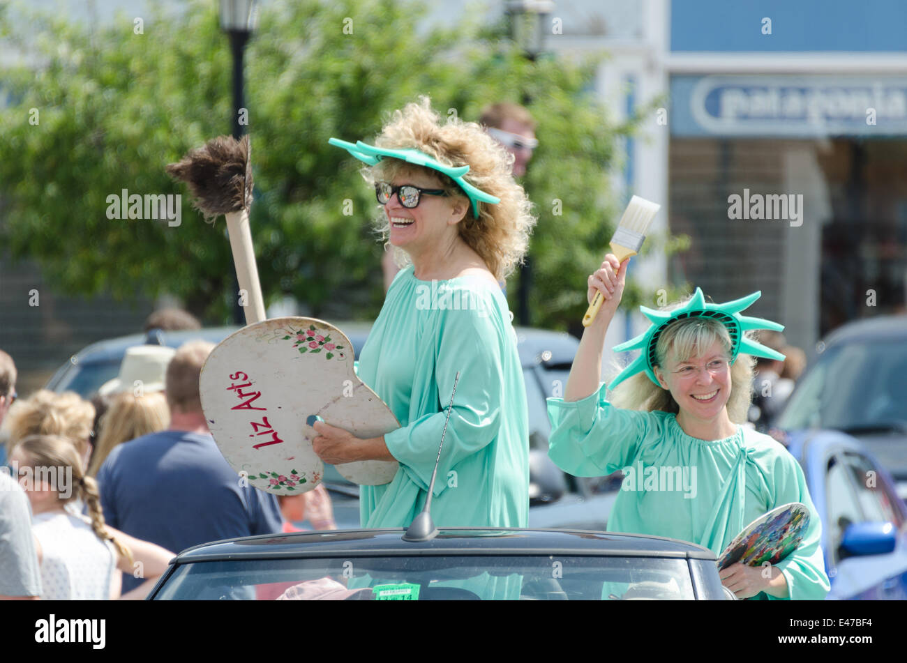 Bar Harbor, Maine, USA. 04th July, 2014. Independence Day Parade Bar Harbor Maine. Pictured: Two artists dressed as the Statue of Liberty ride the ArtWaves Studio float in the Independence Day Parade Credit:  Jennifer Booher/Alamy Live News Stock Photo