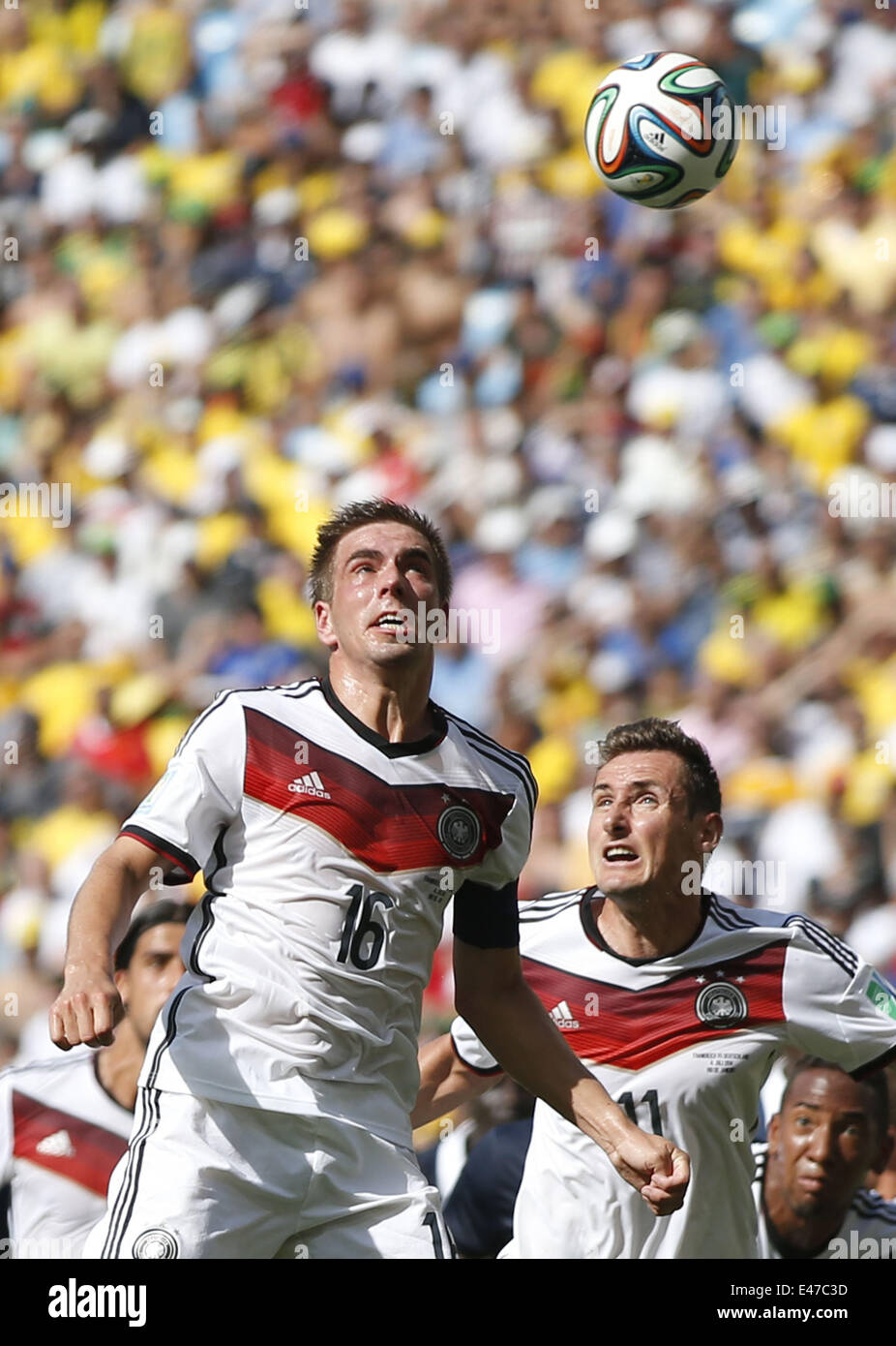 Rio De Janeiro, Brazil. 4th July, 2014. Germany's Philipp Lahm (front) competes for a header during a quarter-finals match between France and Germany of 2014 FIFA World Cup at the Estadio do Maracana Stadium in Rio de Janeiro, Brazil, on July 4, 2014. Credit:  Wang Lili/Xinhua/Alamy Live News Stock Photo