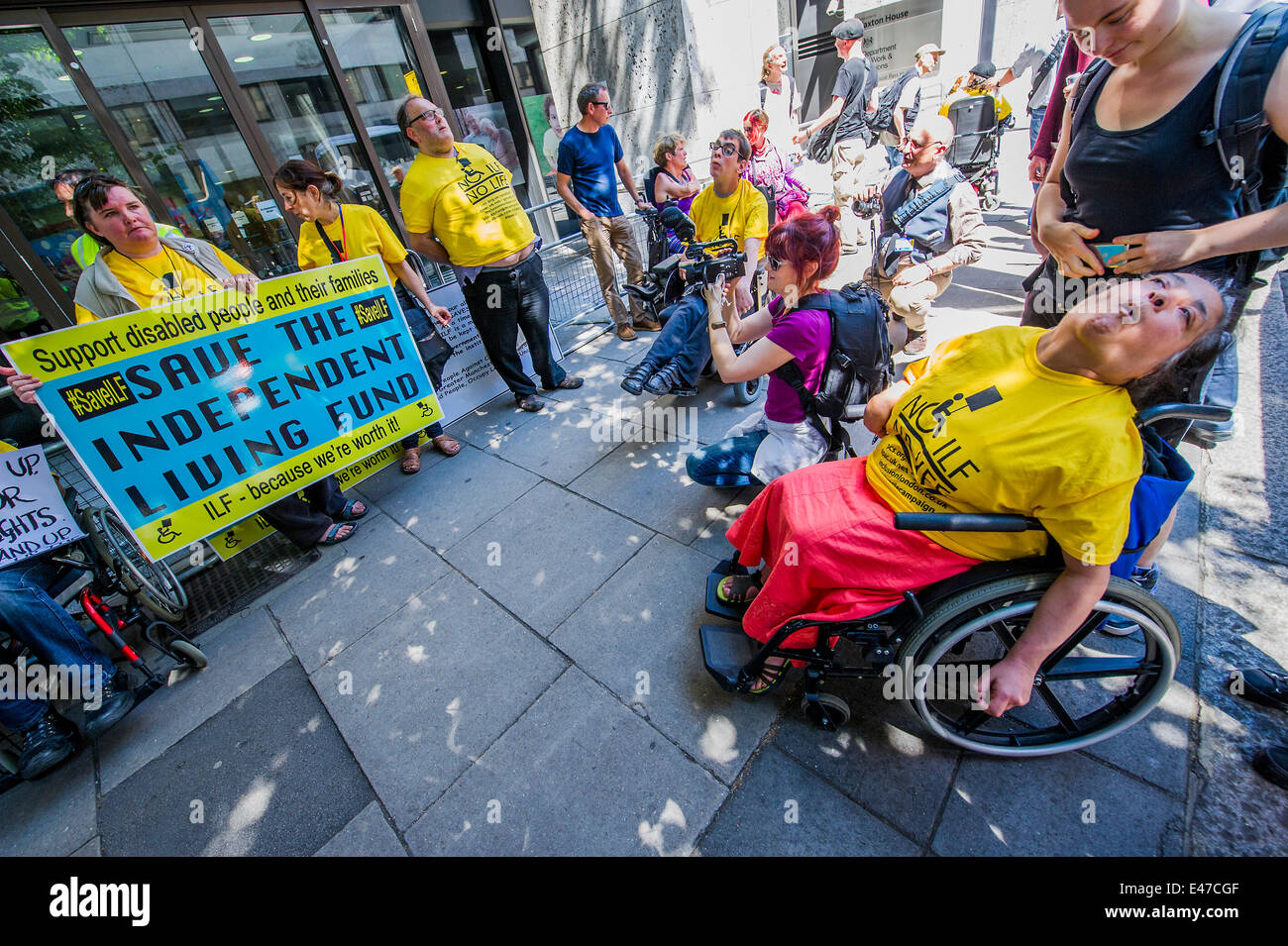 London, UK. 04th July, 2014. DPAC organise a protest outside the Department of Work and Pensions to demand that they save the Independent Living Fund. There is a heavy police presence in the background, after the Abbey closure at the weekend, but the liaison officers are very friendly. Westminster, London, UK 04 July 2014. Credit:  Guy Bell/Alamy Live News Stock Photo