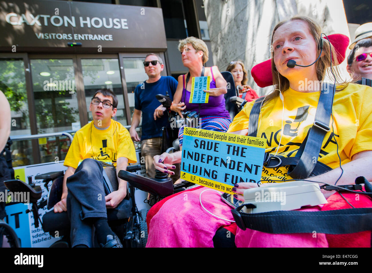 London, UK. 04th July, 2014. DPAC organise a protest outside the Department of Work and Pensions to demand that they save the Independent Living Fund. There is a heavy police presence in the background, after the Abbey closure at the weekend, but the liaison officers are very friendly. Westminster, London, UK 04 July 2014. Credit:  Guy Bell/Alamy Live News Stock Photo