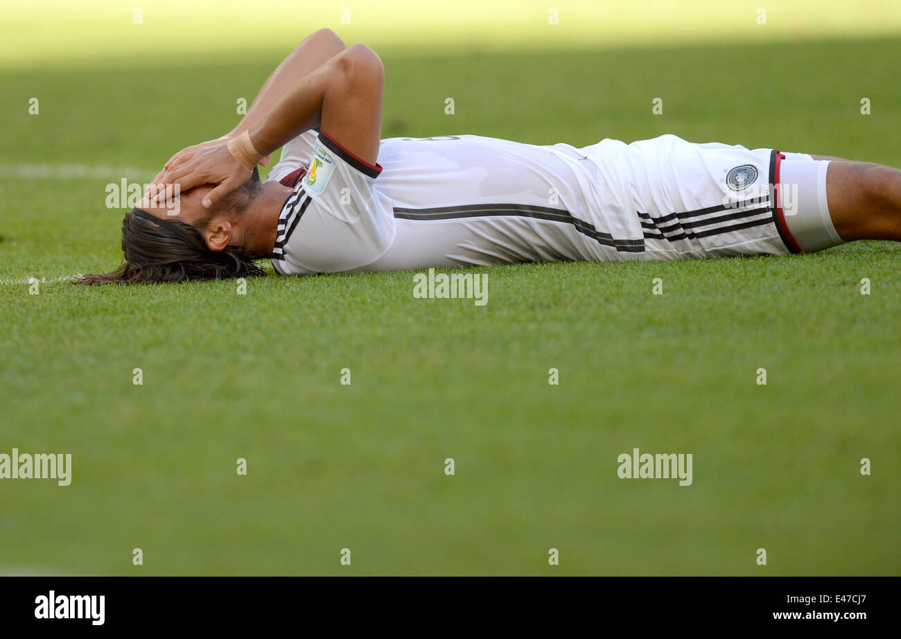 Rio de Janeiro, Brazil. 04th July, 2014. Sami Khedira of Germany lies on the pitch during the FIFA World Cup 2014 quarter final soccer match between France and Germany at Estadio do Maracana in Rio de Janeiro, Brazil, 04 July 2014. Photo: Thomas Eisenhuth/dpa/Alamy Live News Stock Photo