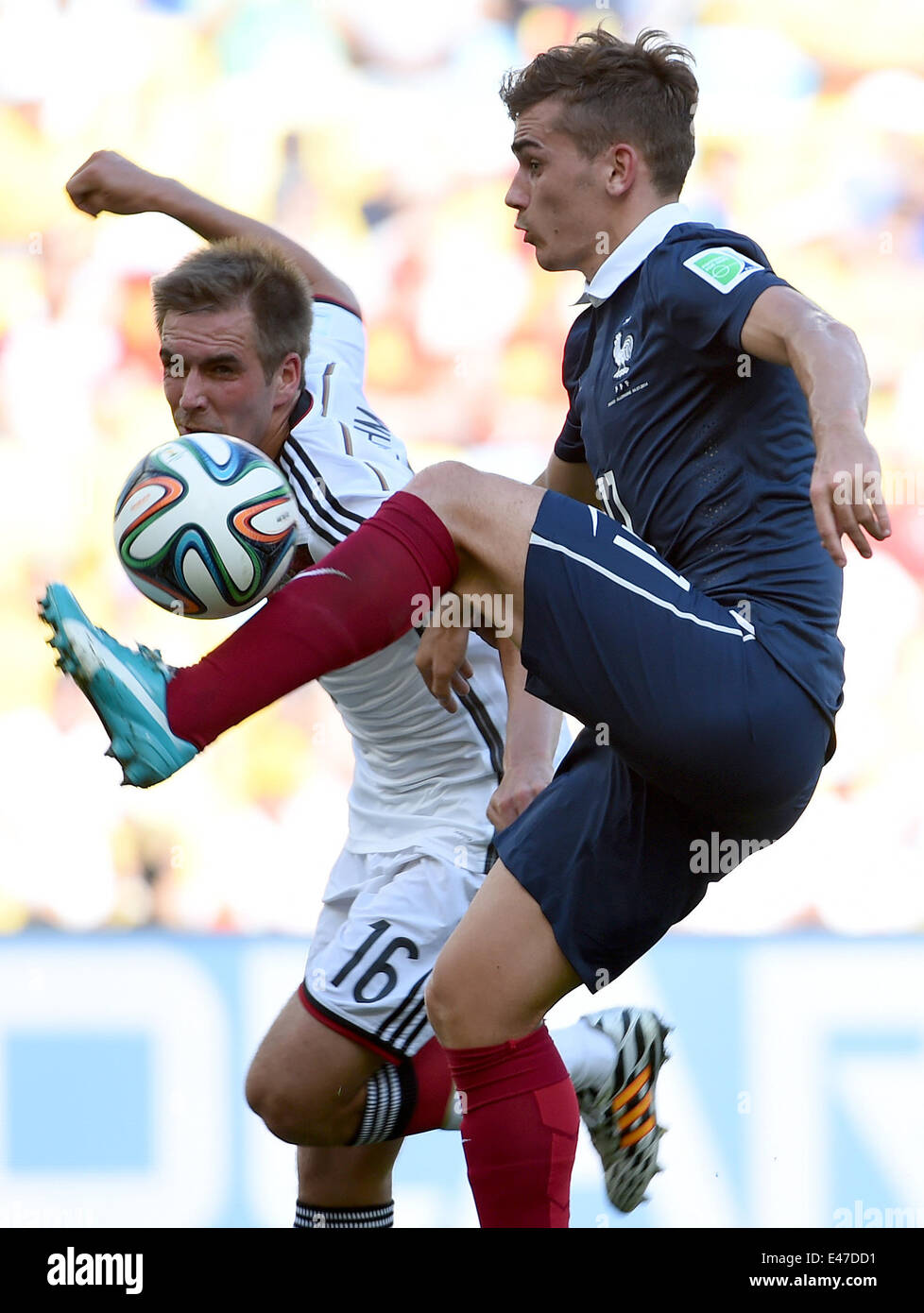 Rio De Janeiro, Brazil. 4th July, 2014. France's Antoine Griezmann vies with Germany's Philipp Lahm during a quarter-finals match between France and Germany of 2014 FIFA World Cup at the Estadio do Maracana Stadium in Rio de Janeiro, Brazil, on July 4, 2014. Credit:  Wang Yuguo/Xinhua/Alamy Live News Stock Photo